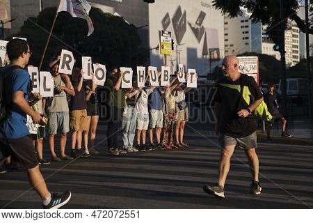 Buenos Aires, Argentina; March 3, 2023: A Passerby Looks At Signs Held By A Group Of Environmentalis