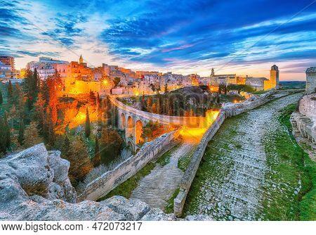 Fabulous View On Gravina In Puglia Ancient Town, Bridge And Canyon At Sunrise. Panoramic View Of Old