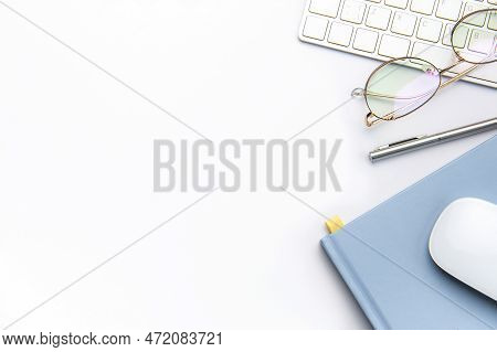 Keyboard, Computer Mouse And Notebook With Pen On White Office Desk.  Directly Above Shot Of Office 