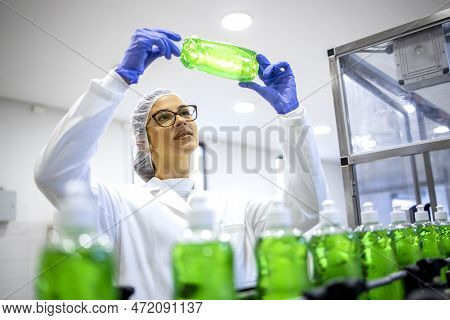 Experienced Female Factory Supervisor Checking Quality Of Sanitation Chemicals Detergent And Soap.