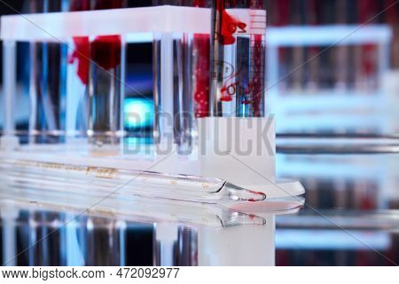 Laboratory Glass Pipette And Test Tubes With Blood. Lab Equipment For Medicine Reserarch.