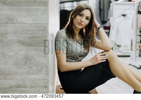 Woman With Dress In The Checkroom. A Clothing Store