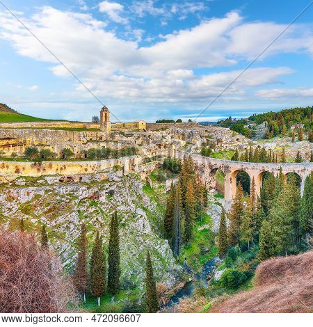 Fabulous View On Gravina In Puglia Ancient Town, Bridge And Canyon At Sunrise. Panoramic View Of Old
