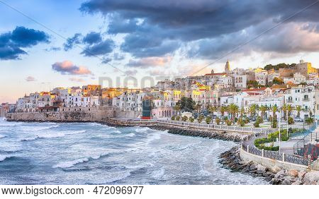 Breathtaking View Of Historic Center And Promenade Of The City Of Vieste At Sunset. View At The Coas