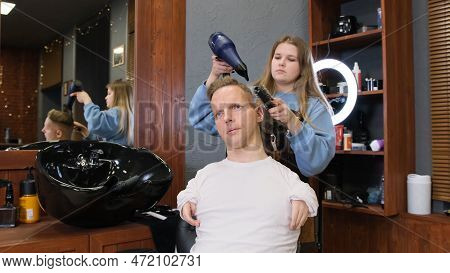 A Hairdresser Girl In A Beauty Salon Does Hair Styling For A Male Client With Disabilities