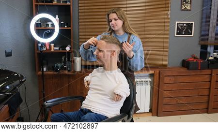A Man With Disabilities Gets His Hair Cut And Styled In A Barber Shop.