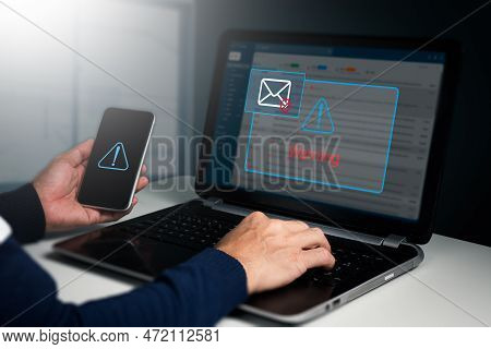 A Businessman Sees A Caution Window While Working On A Laptop At Home. Network Security Concept, Phi
