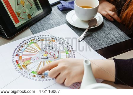 Tver, Russia - February 12, 2023: A Woman At The Table Is Studying A Rave Mandala By Human Design. R