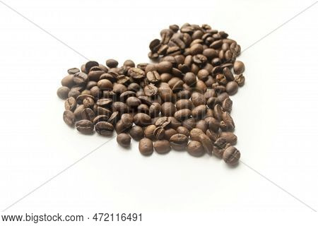 A Heart Made Of Coffee Beans. On A White Background Is A Silhouette Of A Heart Made Of Coffee Beans.