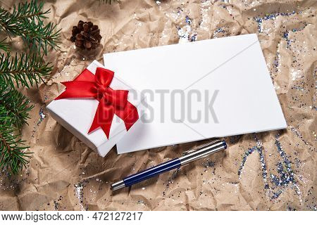 Several White Sheets Of Stationery For Writing On A New Years Background And A Gift Box With A Beaut