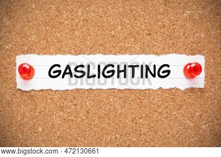 Word Gaslighting Handwritten On White Paper Pinned On Cork Bulletin Board. Concept About Psychologic
