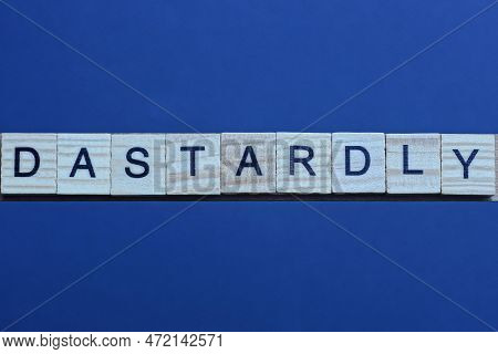Text The Word Dastardly From Brown Wooden Small Letters On A Black Table