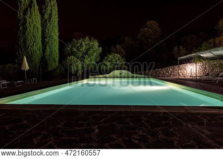 Illuminated Swimming Pool On The Montemassi Hillside Surrounded By Cypresses And Oleanders N The Pro