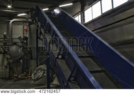 Shredding Waste Paper Conveyor Belt For Recycling Wrap, Garbage And Cardboard Against Bales Of Used 