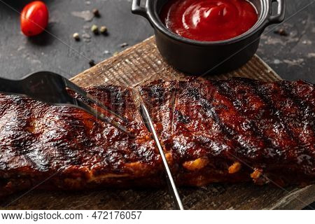 Grilled And Smoked Ribs With Barbeque Sauce. Delicious Barbecued Ribs. Food Recipe Background. Close