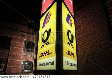 Aachen, Germany - November 8, 2022: Selective Blur On Deutsche Post Logo And Dhl Sign In Front Of Th