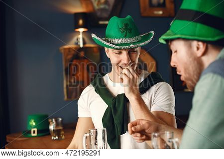 Men Celebrate St. Patricks Day At Bar With A Mug Of Beer