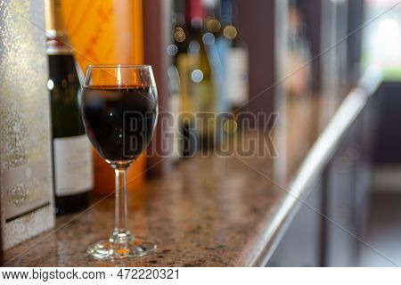 Red Wine Served On A Bar With Other Wines In The. Background