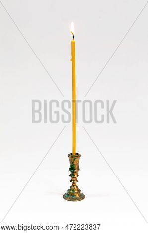 Thin Church Burning Wax Candle In The Bronze Candleholder. Small Fire, Isolated Over White. Prayer, 