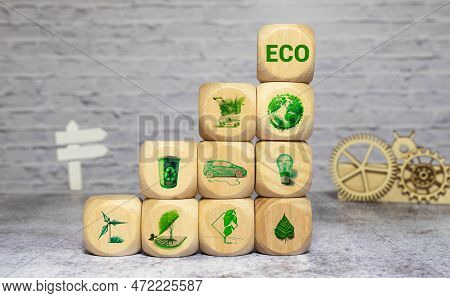 The Hand Puts Cubes In The Word Eco. Ecological Concept And Green Energy And Energy Saving, Green En