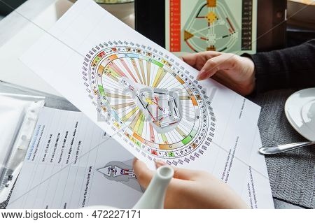 Tver, Russia - February 12, 2023: A Woman At The Table Is Studying A Rave Mandala By Human Design. R