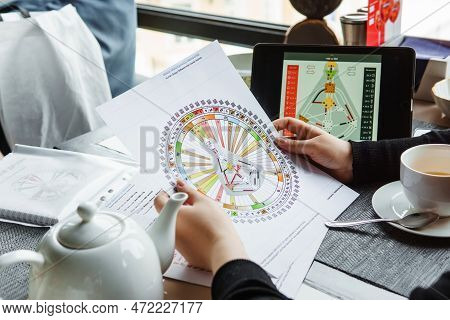 Tver, Russia - February 12, 2023: A Woman At The Table Is Studying A Rave Mandala By Human Design. R