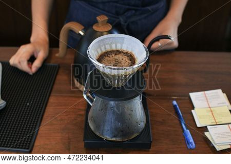 Barista Preparing Coffee Pour Over Coffee Maker And Drip Kettle. Coffee Shop Concept. Vintage Tone.