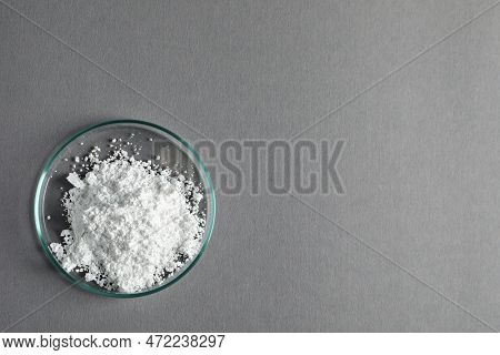 Petri Dish With Calcium Carbonate Powder On Grey Table, Top View. Space For Text