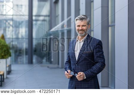 Portrait Of Happy Successful Smiling Gray Haired Businessman, Man In Business Suit Standing Outside 