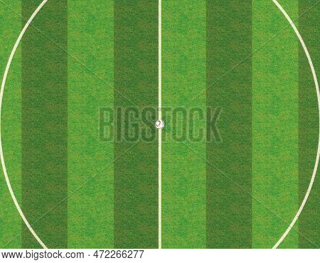 A Soccer Ball On The Centre Line Of A Soccer Stadium With Goals On A Marked Green Grass Pitch Under 