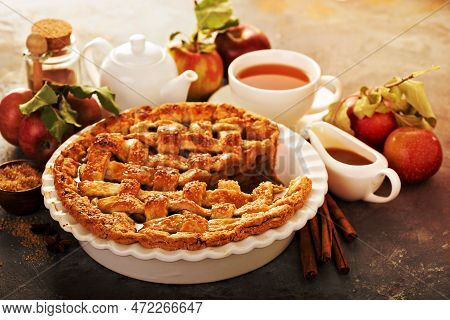 Apple Pie Decorated With Lattice With Caramel Sauce And Tea, Fall Baking Concept