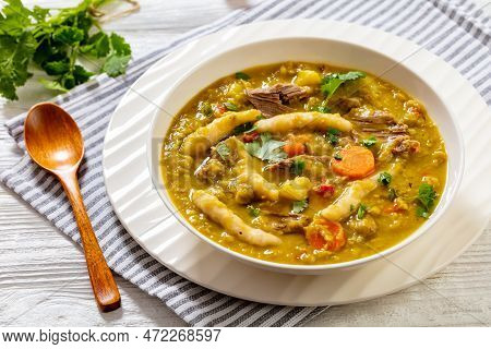 Gungo Peas, Pigeon Peas Soup With Dumplings , Vegetables And Beef In White Bowl On White Table, Jama