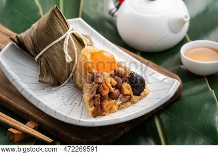 Zongzi. Rice Dumpling For Dragon Boat Festival On Green Leaf Background With Ingredient.