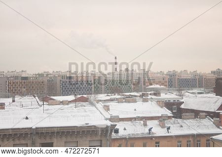 View Of The Roofs Of The City In Winter, Boiler Room Pipe Over The City