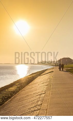 Colorful Sun Reflecting In The Sea  At The Dike In Wilhelmshaven, Germany