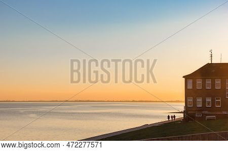 Sunset Colors Over The Sea And Dike In Wilhelmshaven, Germany