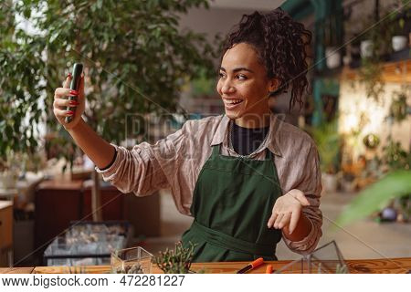 Smiling Woman Florist Taking Selfie With Her Plants For Publishing In Social Media In Florar Studio