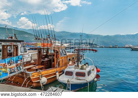 Budva, Montenegro - June 17, 2021: Fishing Boats With Fishing Rods Against The Backdrop Of Mountains