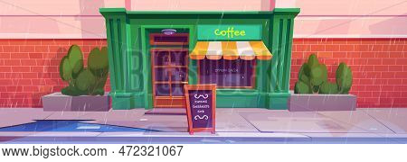 City Street With Coffee Shop Front In Rain. Cafe Entrance In Building Facade And Signboard Outside O
