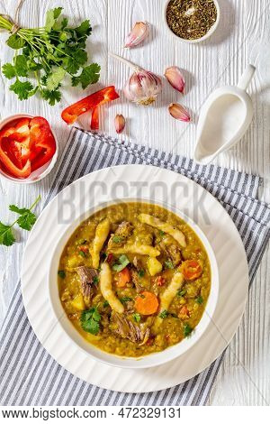 Gungo Peas, Pigeon Peas Soup With Dumplings , Vegetables And Beef In White Bowl On White Wood Table,