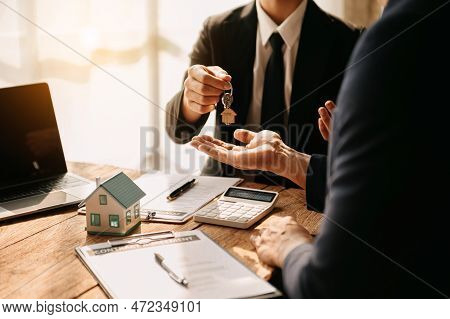 Buying A Home Or Insurance Deal, An Insurance Agent Pointing A Pen To Those Interested In Renting A 