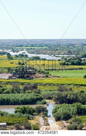 People Crossing A Flooded Bridge Over A Channel Of The Flooded Orange River As Seen From Tierberg At
