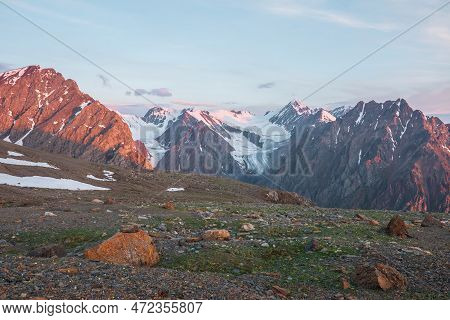 Vivid Alpine Landscape With High Snow Mountains And Large Glacier In Sunrise Colors. Colorful Mounta