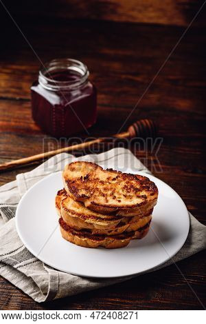 French Toasts On White Plate Over Wooden Surface