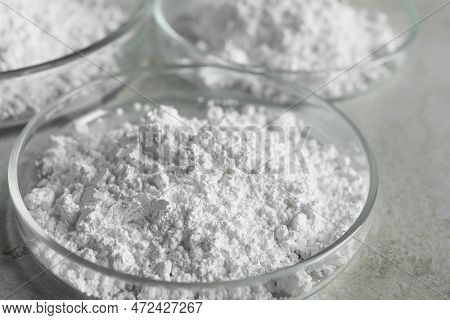 Petri Dishes With Calcium Carbonate Powder On Light Grey Table, Closeup