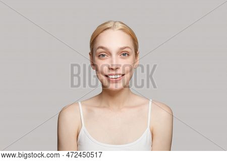 Portrait Of Beautiful Woman With Blonde Hair Smiling Isolated On Grey. Beauty, Cosmetics, Skincare, 