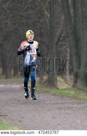 Ostrava, Czechia - 02.04.2023: Vertical Shot Of Male Runners In Sportswear Competing During Winter A