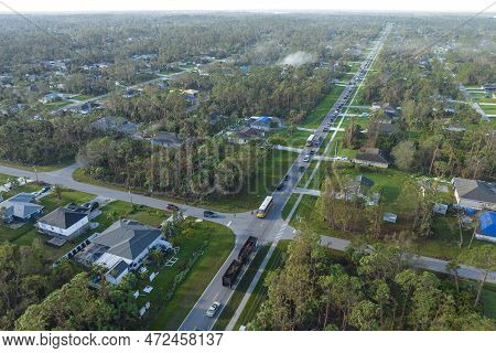 Aerial View Of American Yellow School Bus Picking Up Children At Sidewalk Bus Stop For Their Lessong