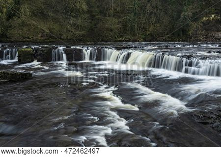 Beautiful Peaceful Landscape Image Of Aysgarth Falls In Yorkshire Dales In England During Winter Mor