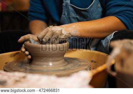 Close Up On Skillful Hands Sculpting Pottery Jar On Potter Wheel